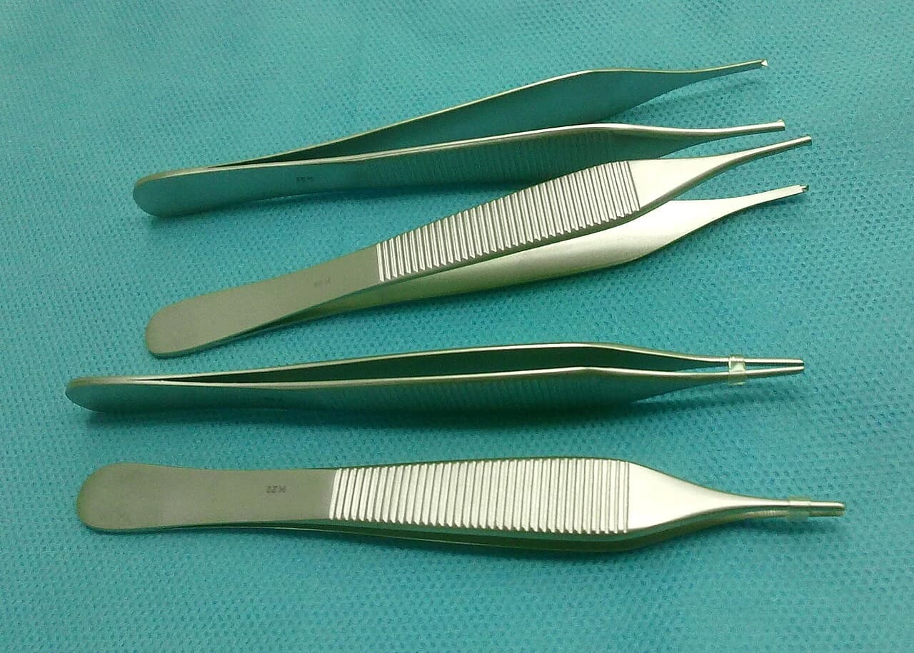 Adson-pattern forceps: compare the toothed and dressing-tip variants.